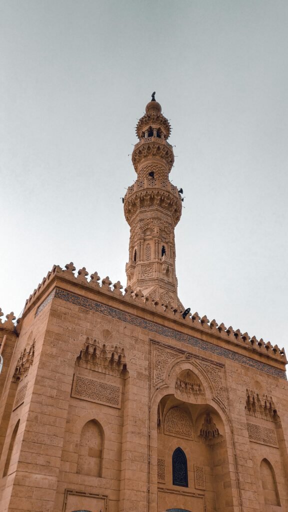 Low angle shot of a mosque's intricate minaret in Khartoum, Sudan, showcasing beautiful Islamic architecture.