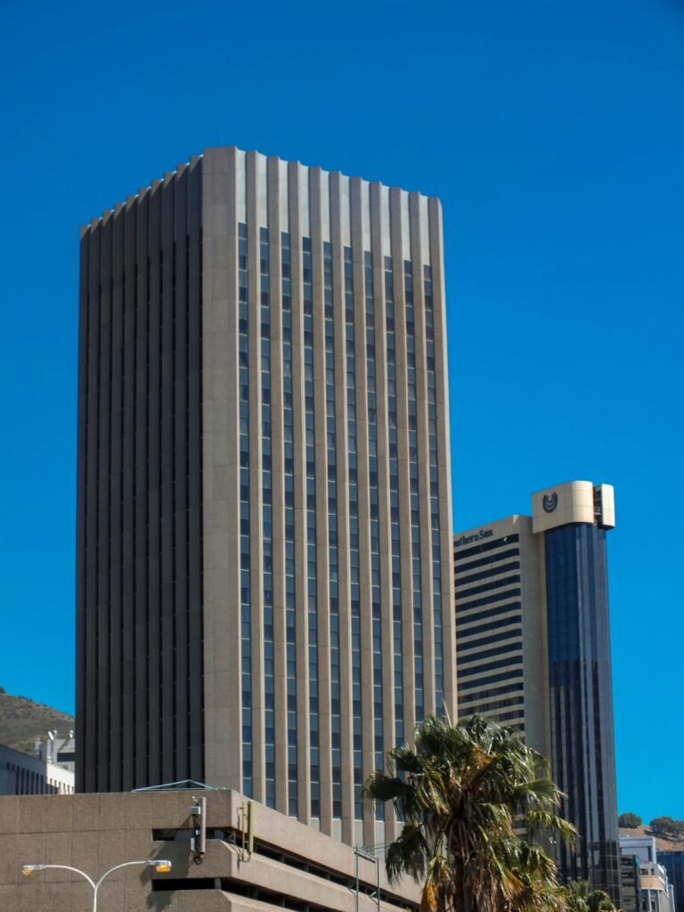 Elevated view of skyscrapers against a clear blue sky in Cape Town's urban area.