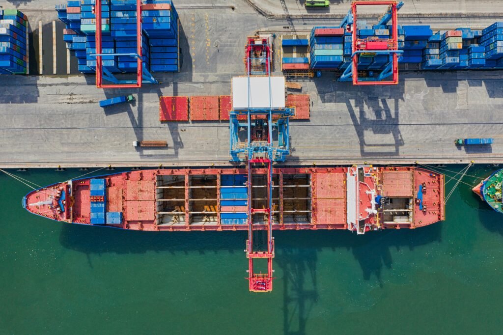 Drone shot of cargo ship and containers at North Jakarta port, illustrating trade and transportation.