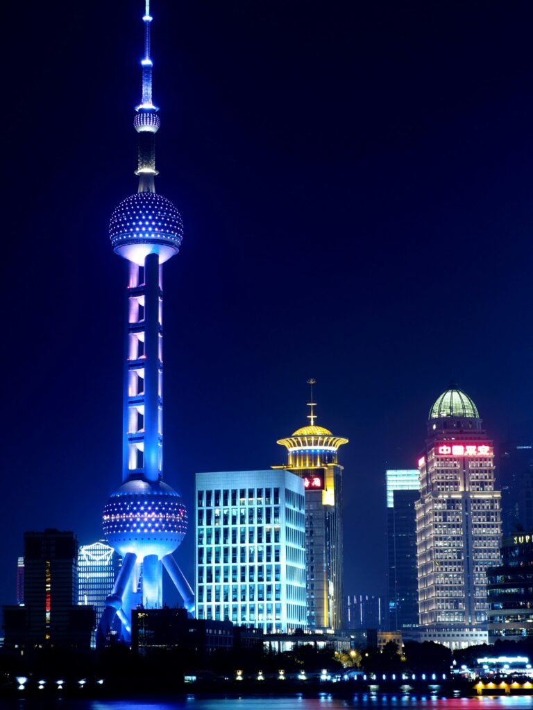 Breathtaking view of Shanghai's illuminated Pudong skyline featuring the Oriental Pearl Tower.